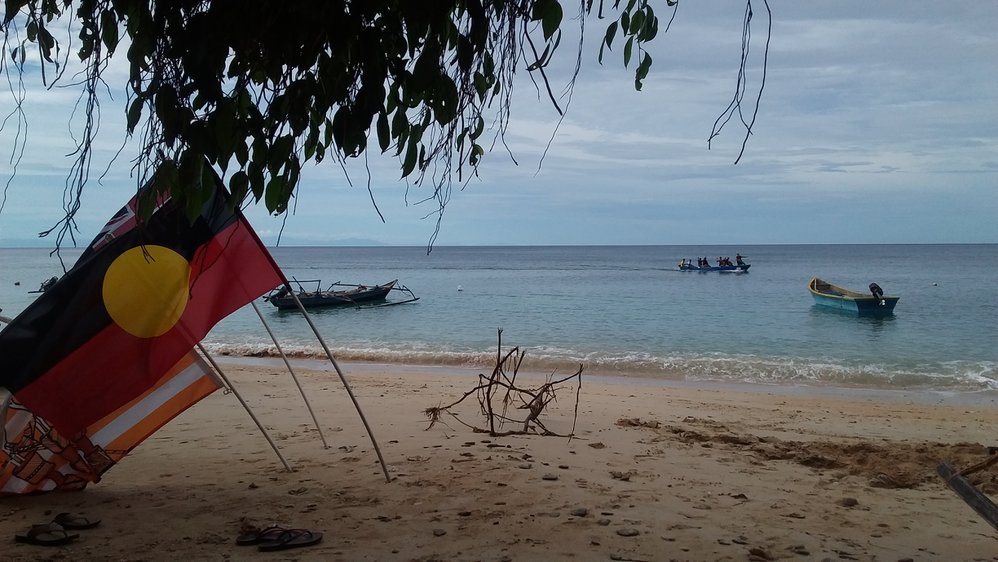 Aust flags on beach Watebo village
