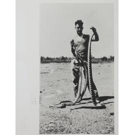 Man Holding Dead Snakes