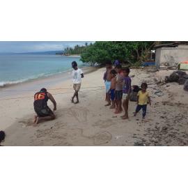 Anthony making sand creations for village kids